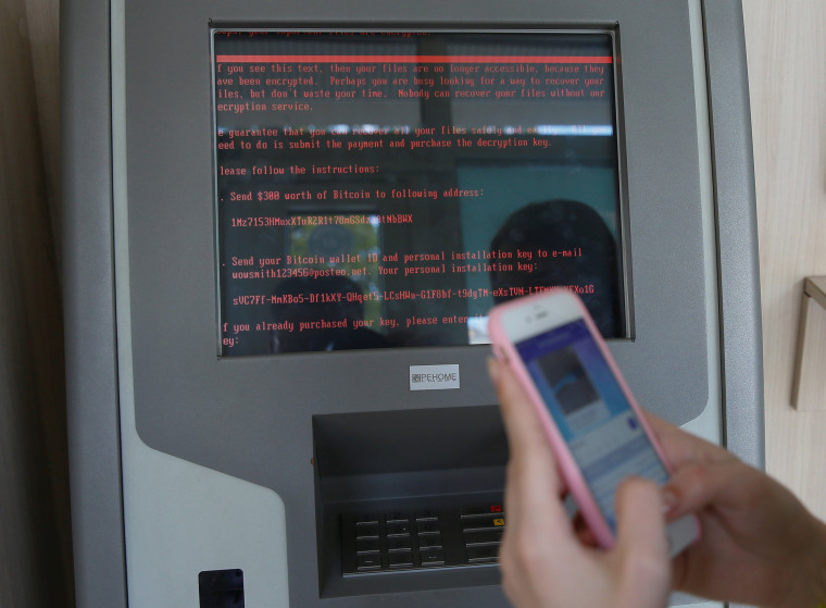 Image: A message demanding money is seen on a monitor of a payment terminal at a branch of Ukraine's state-owned bank Oschadbank after Ukrainian institutions were hit by a wave of cyber attacks earlier in the day, in Kiev