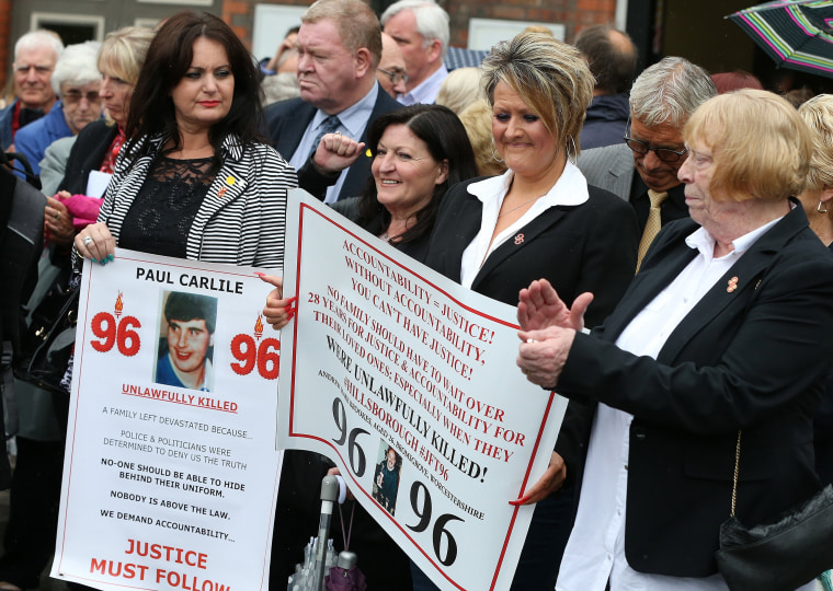 Image: Family of the 96 Hillsborough victims celebrate news of the criminal charges.