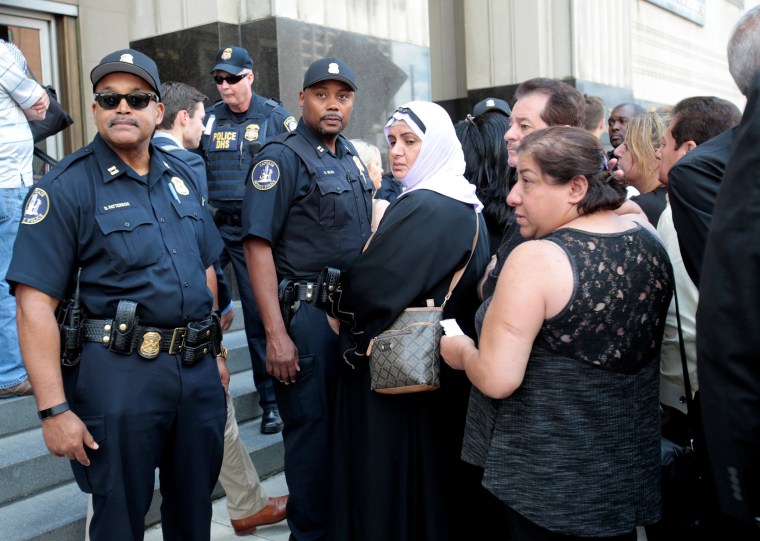 Image: Family members of detainees line up to enter the federal court just before a hearing to consider a class-action lawsuit filed on behalf of Iraqi nationals facing deportation, in Detroit