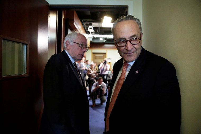 Image:  Schumer and Sanders arrive at a news conference on release of the president's FY2018 budget proposal on Capitol Hill in Washington