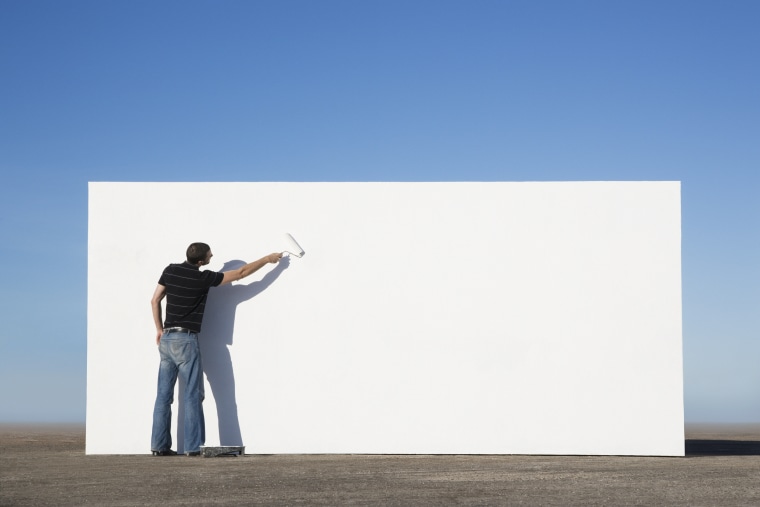 Image: Man painting wall outdoors