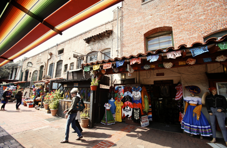 Image: Tourists shop at Olvera Street stores at El Pueblo de Los Angeles Historic  District in Los Angeles.