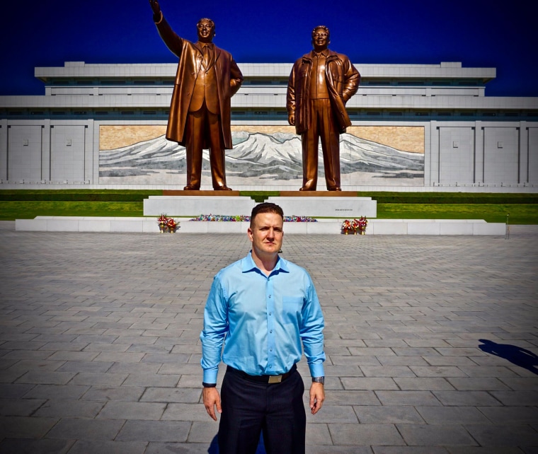 Image: Randy Williams poses in front of the Korean Revolution Museum building in Pyongyang
