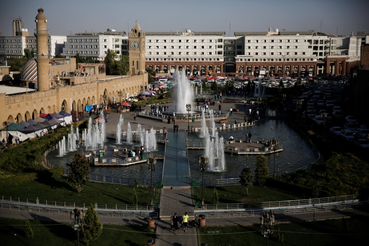 Image: People make their way on Shar Garden square in Erbil
