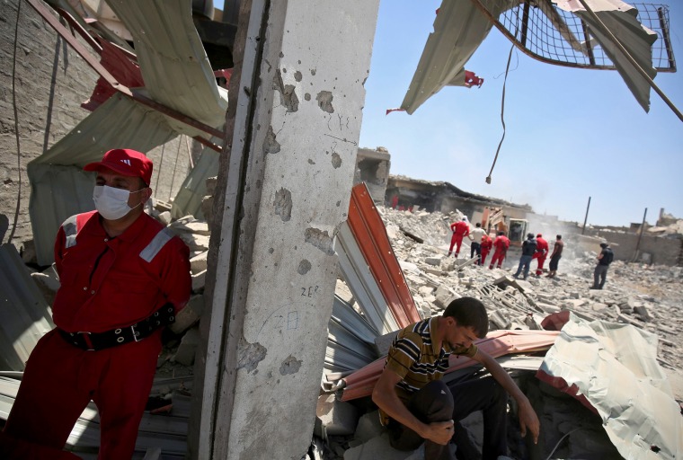 Image: Iraqi civil defense search and rescue workers search for the bodies of victims under the rubble of buildings in western Mosul's Zanjili district on June 27.