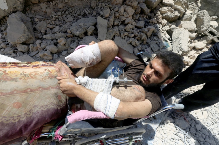 Image: A wounded displaced Iraqi man who fled from clashes sits in a wheelchair on June 30.