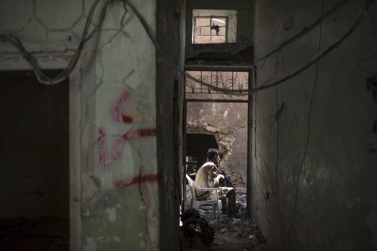 Image: An Iraqi Special Forces soldier guards an alley during fighting on June 30.