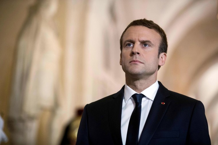 Image: French President Emmanuel Macron walks through the Galerie des Bustes before a special congress gathering both houses of parliament in the palace of Versailles, outside Paris, on July 3, 2017.