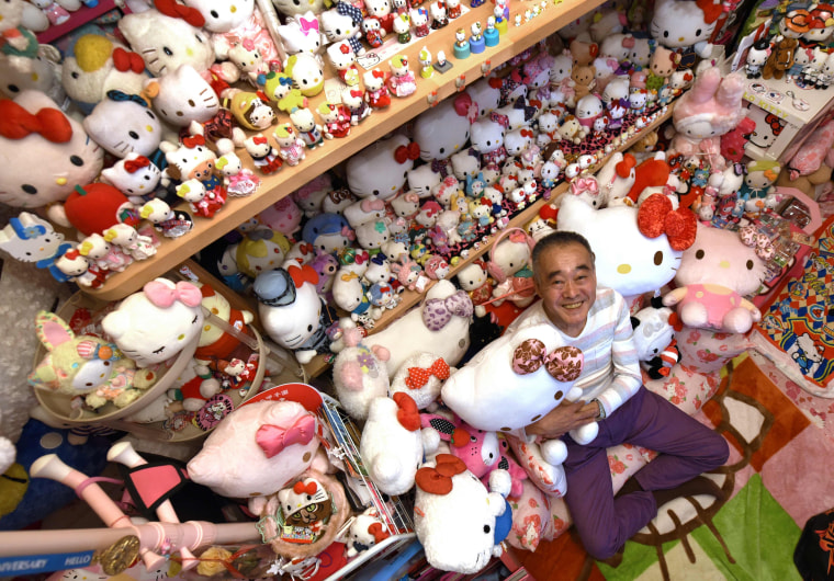 Image: Retired Japanese police officer Masao Gunji posing with his Hello Kitty collection