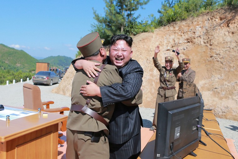 Image: North Korean leader Kim Jong Un reacts with scientists and technicians of the DPRK Academy of Defence Science after the test-launch of Hwasong-14 in this undated photo released by KCNA
