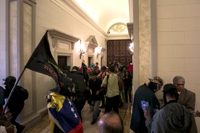 Image: Government supporters break into Venezuelan Parliament and wound deputies