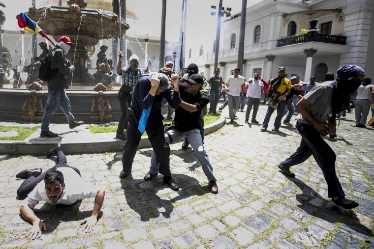 Image: Government supporters break into Venezuelan Parliament and wound deputies