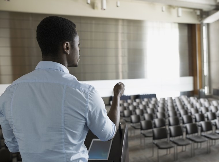 Man rehearsing at podium