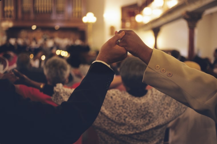 Congregation Holds Hands in Church