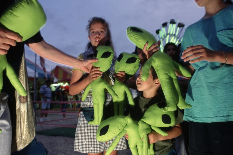 Youngsters Receiving Stuffed Alien Toys at Roswell Carnival