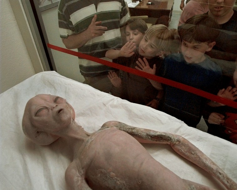 Children look at a model of an alien on display at the UFO Museum and Research Center in Roswell, New Mexico.