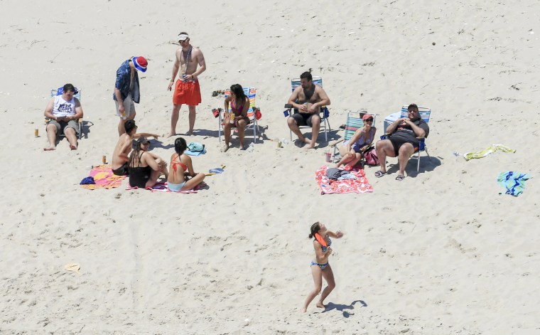 Image: New Jersey Gov. Chris Christie, right, uses the beach with his family and friends at the governor's summer house at Island Beach State Park in New Jersey.