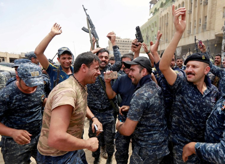 Image: Iraqi police celebrate gains in Mosul, Saturday.