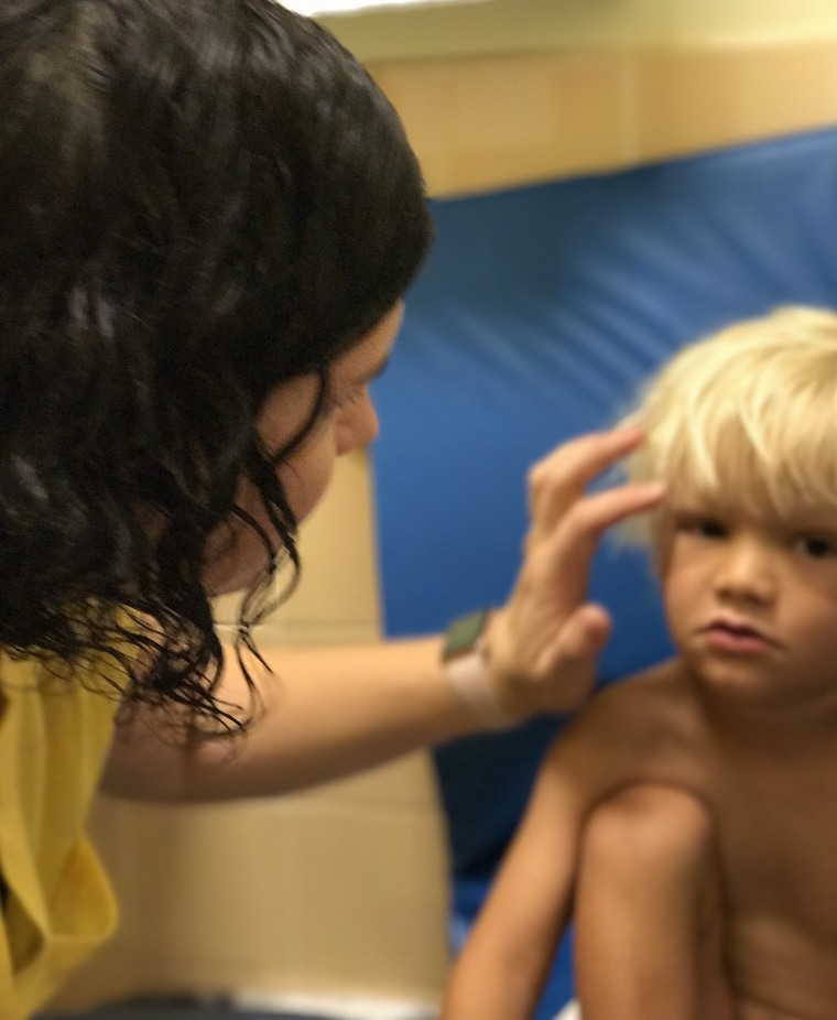 Amos with one of the therapists at the Emory Autism Center.