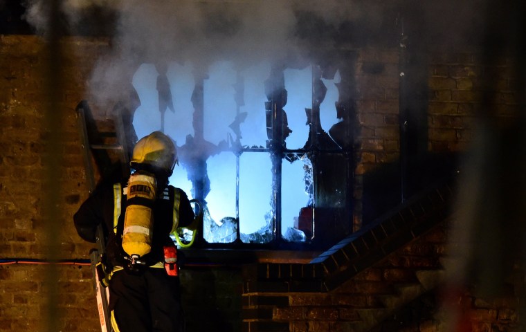 Image: A firefighter tackles a fire at Camden Market in north London