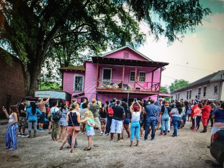 Image: A crowd gathers outside of rapper 2 Chainz pink painted 'Trap House' after Trap Church even hosted in Atlanta, Georgia.