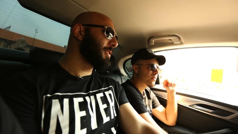 Image: Adel Saflou and his assigned social worker Salim take a taxi en route to Adel's newly assigned home in Deventer, Netherlands