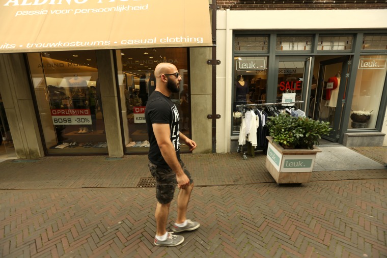 Image: Adel Saflou walks down a quiet street in Deventer, Netherlands