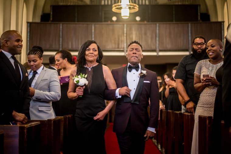 Harrison Guy, left, and his mom walk down the aisle at his wedding to Adrian Homer on April 15, 2017.