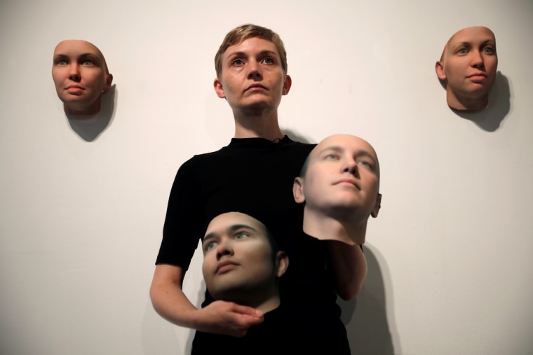 Image: Artist Heather Dewey-Hagborg poses with various 3-D printed masks created from DNA extracted from cheek swabs and hair clippings she received from formerly imprisoned U.S. Army Private Chelsea Manning ahead of exhibition in New York