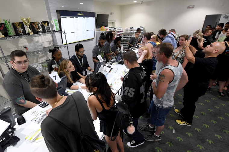 Image: Customers buy cannabis products at Essence Vegas Cannabis Dispensary