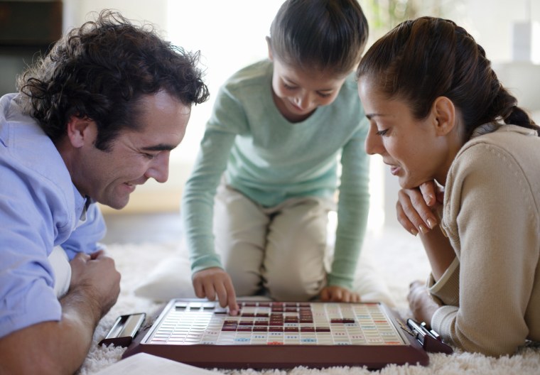 Image: A family plays a board game.