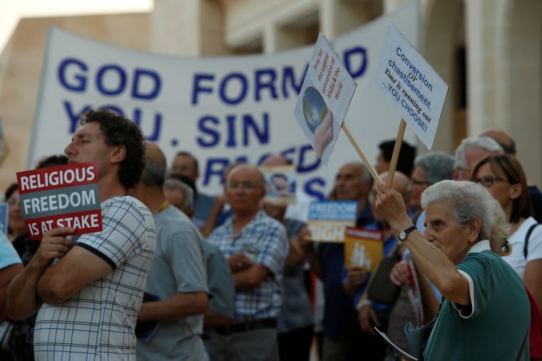 Image: People protest against same-sex marriage, a day before the Maltese parliament is expected to legalise gay marriage, outside Parliament House in Valletta