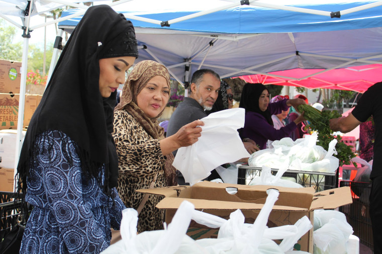 Members of the ICSA distributing food from their food bank.