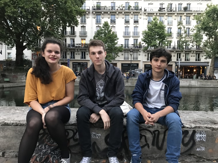 Image: Cloe Gouilpain, Louis Marcodini and Dorian Ghiotti sit on the banks of Canal St Martin in Paris's 10th arrondissement in Paris