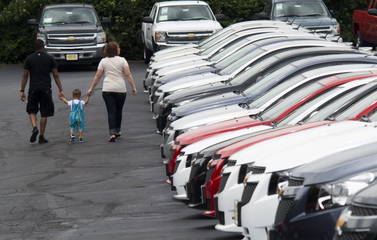 Image: People browse through rows of cars for sale at a car dealership in Columbus, Ohio.