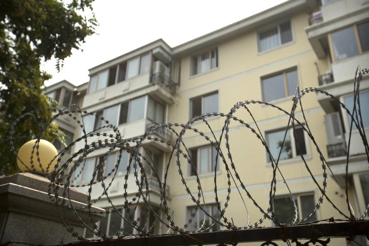 Coils of barbed wire top a fence next to an apartment building where Liu Xia, the wife of Chinese dissident and Nobel Prize winner Liu Xiaobo, had been living under house arrest in Beijing, Friday, July 14, 2017.