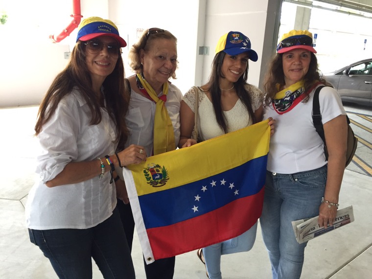 A group of women wear the Venezuelan flag colors after voting against Nicolas Maduro in an unofficial referendum at the campus of Miami Dade College in Doral, Florida.