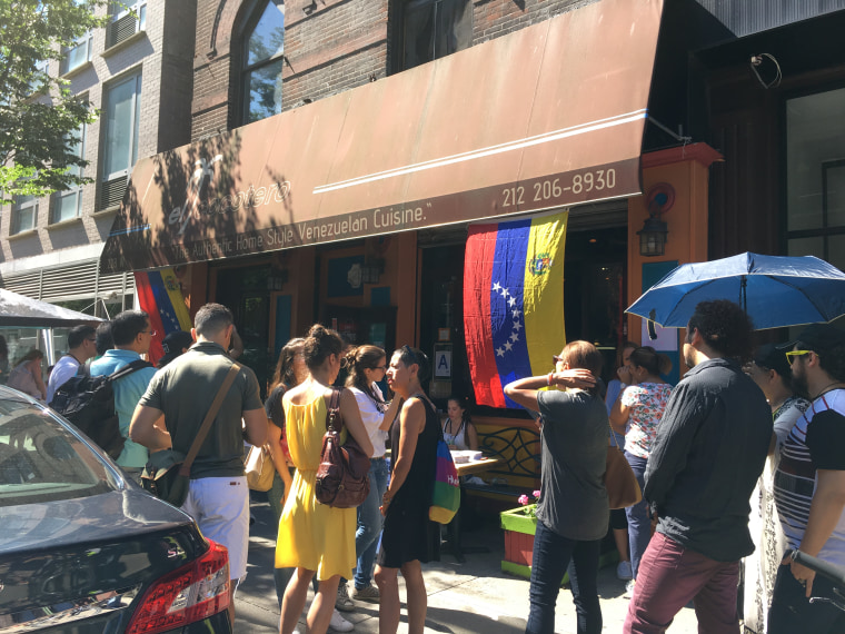 In New York City, Venezuelans gather in front of the "El Cocotero" restaurant, one of the polling places in Sunday's vote.