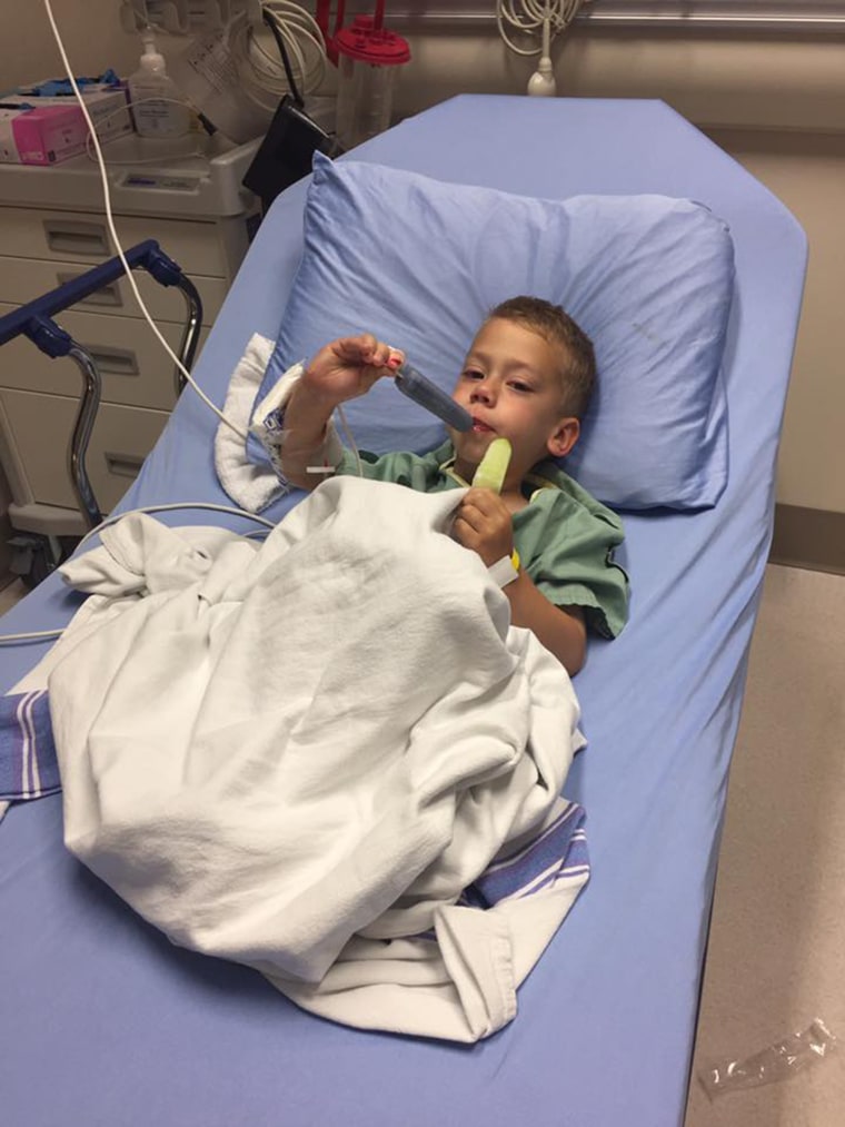 Oliver Schenn enjoys popsicles after surgery to remove a wire barbecue brush bristle that lodged in his throat.