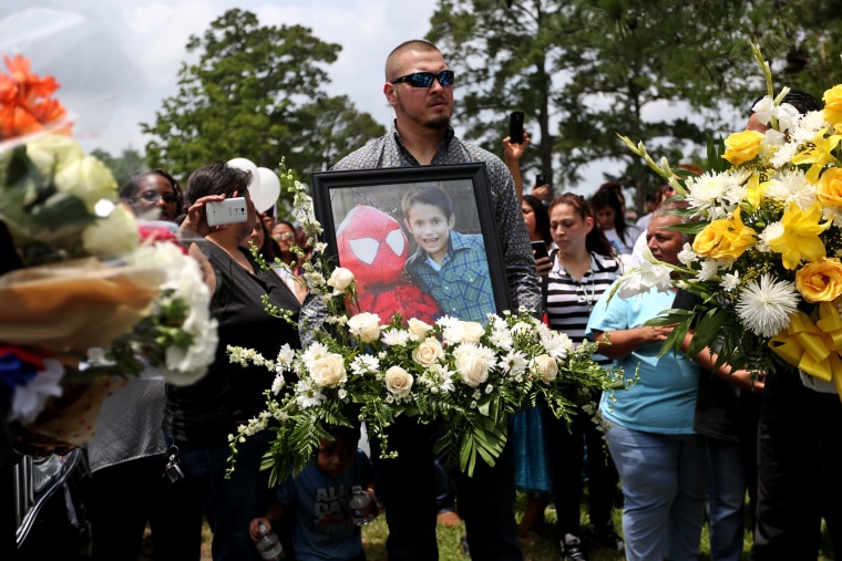 Flowers and a photo of Josue Flores to be placed at his grave site