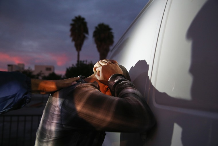 Image: A man is detained by Immigration and Customs Enforcement (ICE), agents early on Oct. 14, 2015 in Los Angeles, Calif.