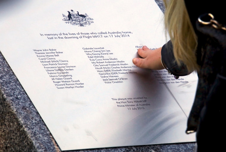 Image: A relative of an Australian victim of Malaysia Airlines jet MH17 touches a memorial that was unveiled outside Parliament House in Canberra, Australia, July 17, 2017.