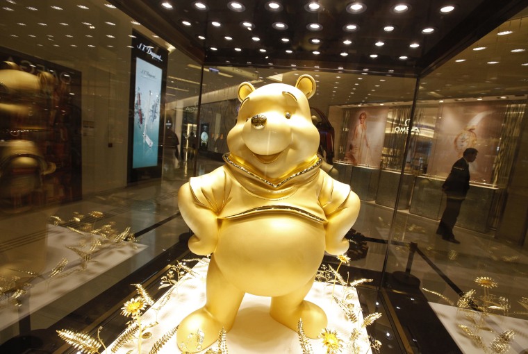 Image: A giant pure gold statue of the Disney character Winnie the Pooh is on display at a shopping mall in Hong Kong