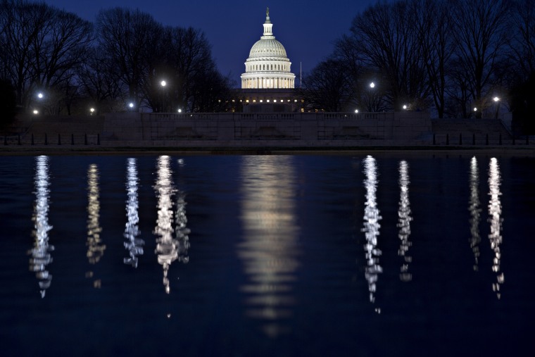 Image: The U.S. Capitol building stands before sunrise in Washington