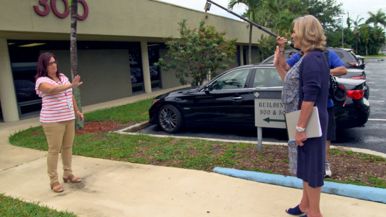 Cynthia McFadden of NBC News, right, attempts to speak with an employee of the London Treatment Center in West Palm Beach, Florida.