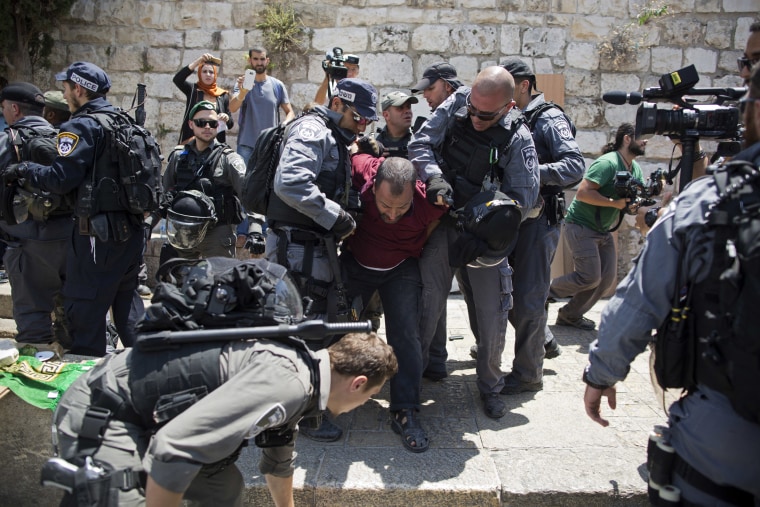 Image: Israeli police officers detain a Palestinian man outside the Lion's Gate