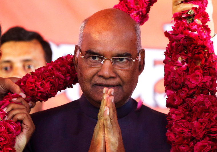 Image: Supporters of Ram Nath Kovind present him with a garland during a welcoming ceremony as part of his nation-wide tour in Ahmedabad