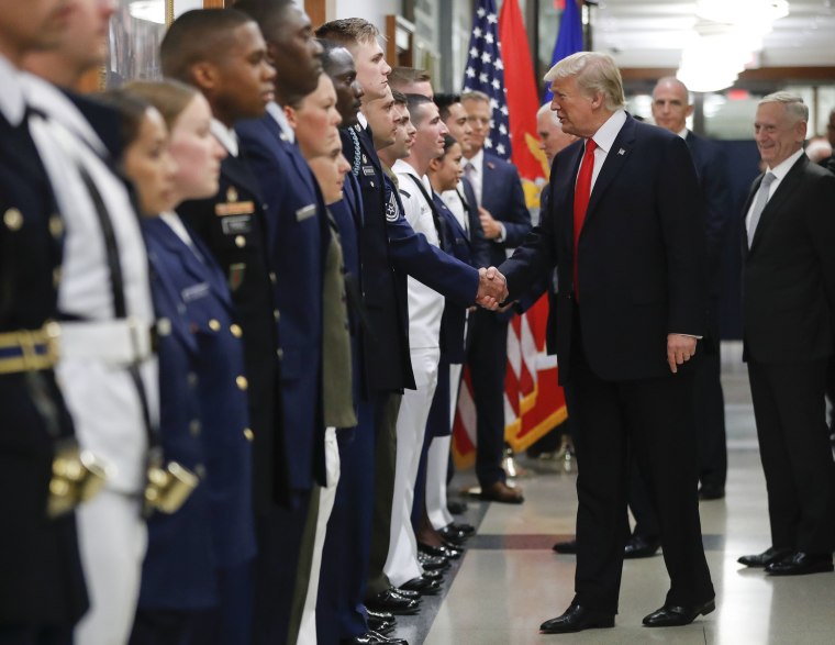 Image: President Donald Trump greets military personnel during his visit to the Pentagon