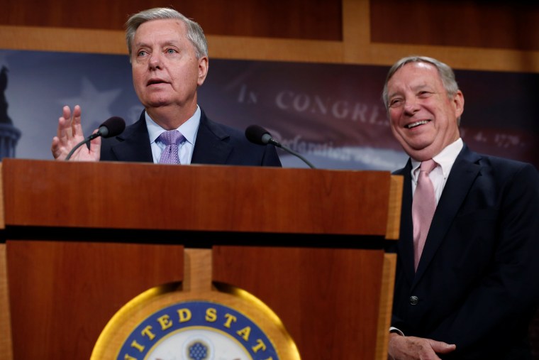 Image: Graham, with Durbin, talks about possible legislation for so-called \"dreamer\" immigrant children as well as the health of McCain at the U.S. Capitol in Washington