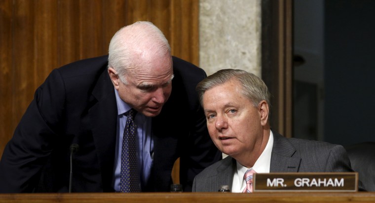 Image: Senate Armed Services Committee Chairman McCain speaks with Republican Presidential hopeful Senator Graham during a committee hearing on Capitol Hill in Washington